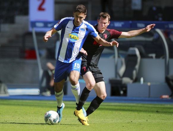 Hertha BSC&#039;s Marko Grujic in action with FC Augsburg&#039;s Stephan Lichtsteiner during the German Bundesliga soccer match between Hertha Berlin and Augsburg at the Olympiastadion in Berlin, Germ ...