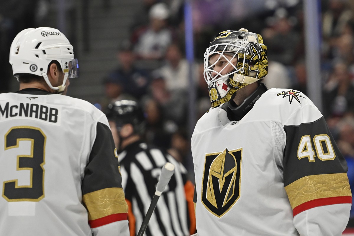 Vegas Golden Knights defenseman Brayden McNabb (3) and goaltender Akira Schmid (40) talk during the first period of an NHL hockey game against the Colorado Avalanche Tuesday, April 8, 2025, in Denver. ...