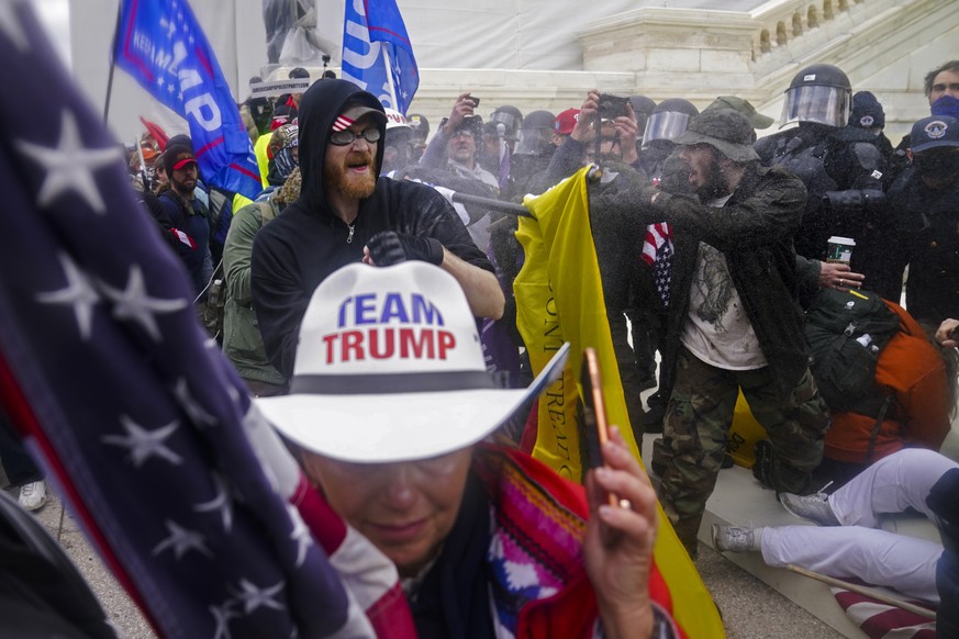 Trump supporters try to break through a police barrier at the Capitol in Washington, on Jan. 6, 2021, as Congress prepared to affirm President-elect Joe Biden&#039;s victory. (AP Photo/John Minchillo)