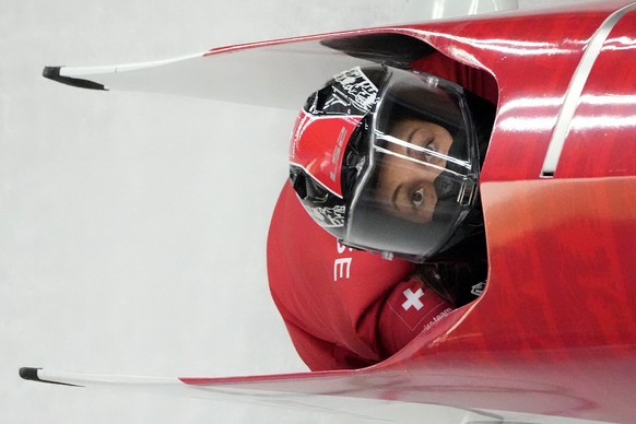 Melanie Hasler of Switzerland speeds along the track during a 2-woman bobsled training at the 2022 Winter Olympics, Wednesday, Feb. 16, 2022, in the Yanqing district of Beijing. (AP Photo/Mark Schiefelbein)