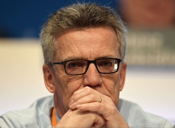 German Interior Minister Thomas de Maziere watches from the podium at the general party conference of the Christian Democratic Union, CDU, in Essen, Germany, Wednesday, Dec. 7, 2016. (AP Photo/Martin  ...