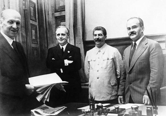 The scene in Moscow on August 23, 1939, after representatives of Nazi Germany and Soviet Russia signed their ten year Non Aggression Pact. Shown from left to right are: Freidrich Gaus, Joachim von Rib ...