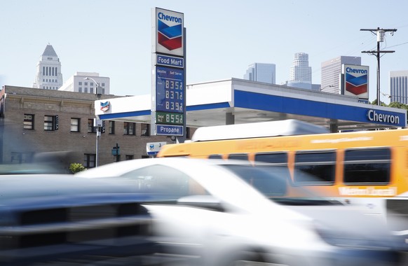 epa10223985 Cars drive by a Chevron gasoline station displaying prices starting at $8.35 US dollars per gallon in Los Angeles, California, USA, 04 October 2022. Average gas prices in Los Angeles Count ...