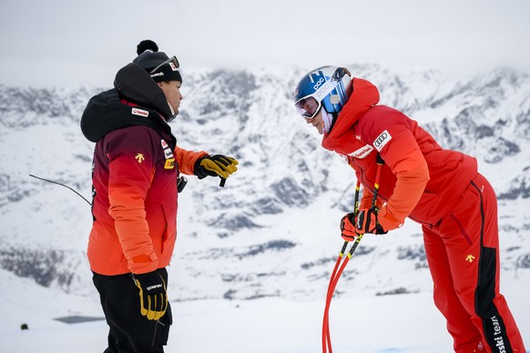 Marco Odermatt of Switzerland, right, inspects the slope with Reto Nydegger, left, men's speed coach for Swiss-ski federation before the men's downhill training race on the new ski course &q ...