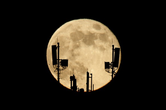 epaselect epa11046160 The full moon, also called the 'Cold Moon', rises over Salgotarjan, Hungary, December 27, 2023. The last full moon of 2023 appears for three days, starting in the evening ...