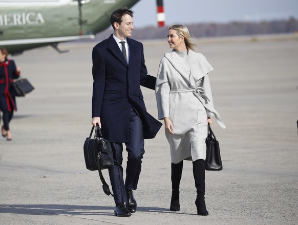 White House Senior Adviser Jared Kushner, left and Ivanka Trump, right, the daughter and assistant to President Donald Trump, walk across the tarmac before boarding Air Force One, Thursday, Nov. 29, 2 ...