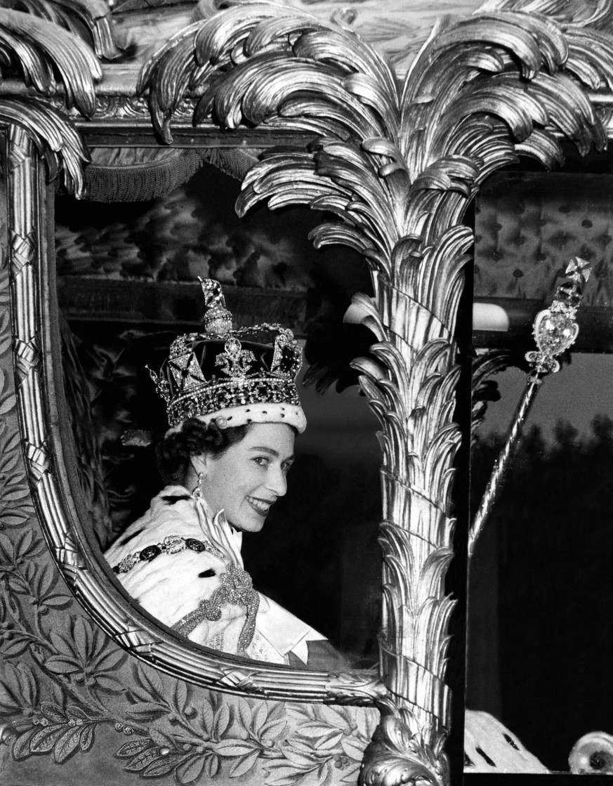 The Queen rides in the golden State Coach into Buckingham Palace at the end of her tirumphal progress from her Coronation at Westminster Abbey , today. She wears the Imperial State Crown , carries the ...