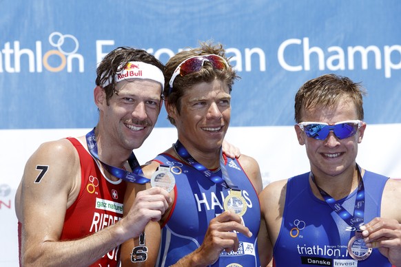 Sven Riederer, of Switzerland, silver medal, David Hauss of France, gold medal, and Kristian Blummenfelt, of Norway, bronze, from left to richt, pose on the podium during the medal ceremony of the ITU ...