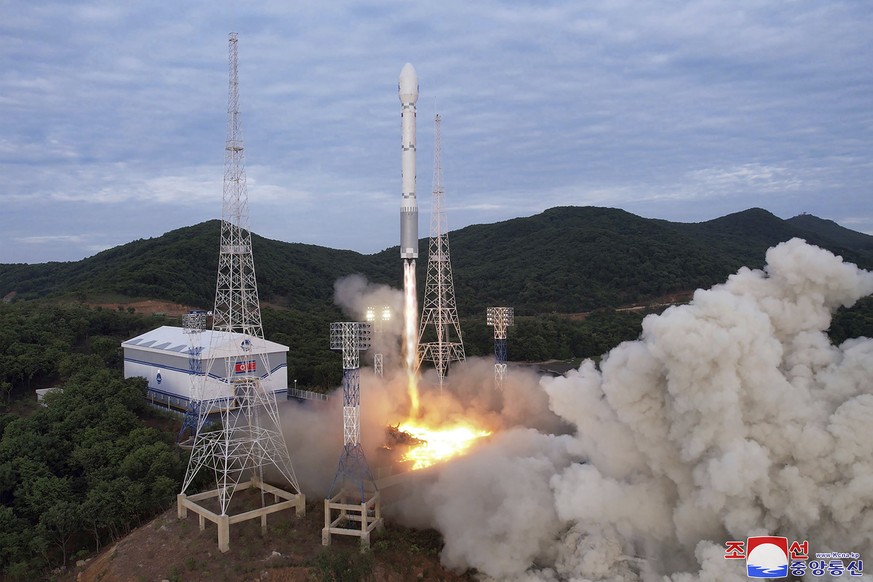 FILE - This photo provided by the North Korean government shows what it says a launch of the newly developed Chollima-1 rocket carrying the Malligyong-1 satellite at the Sohae Satellite Launching Grou ...