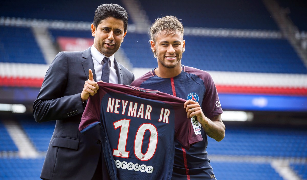 epa06124324 Paris Saint Germain's chairman and CEO Nasser Al-Khelaif (L) and Brazilian striker Neymar Jr (R) pose for photographs with his new PSG jersey after a press conference at the Parc des  ...