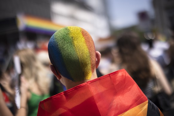 epa10696737 A person with the hair painted in rainbow colours takes part in the Zurich Pride parade in Zurich, Switzerland, 17 June 2023. EPA/MICHAEL BUHOLZER