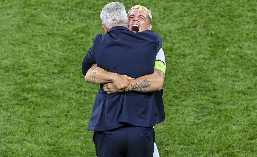 Switzerland&#039;s Granit Xhaka celebrates with manager Vladimir Petkovic after defeating France in a penalty shoot out during the Euro 2020 soccer championship round of 16 match at National Arena sta ...