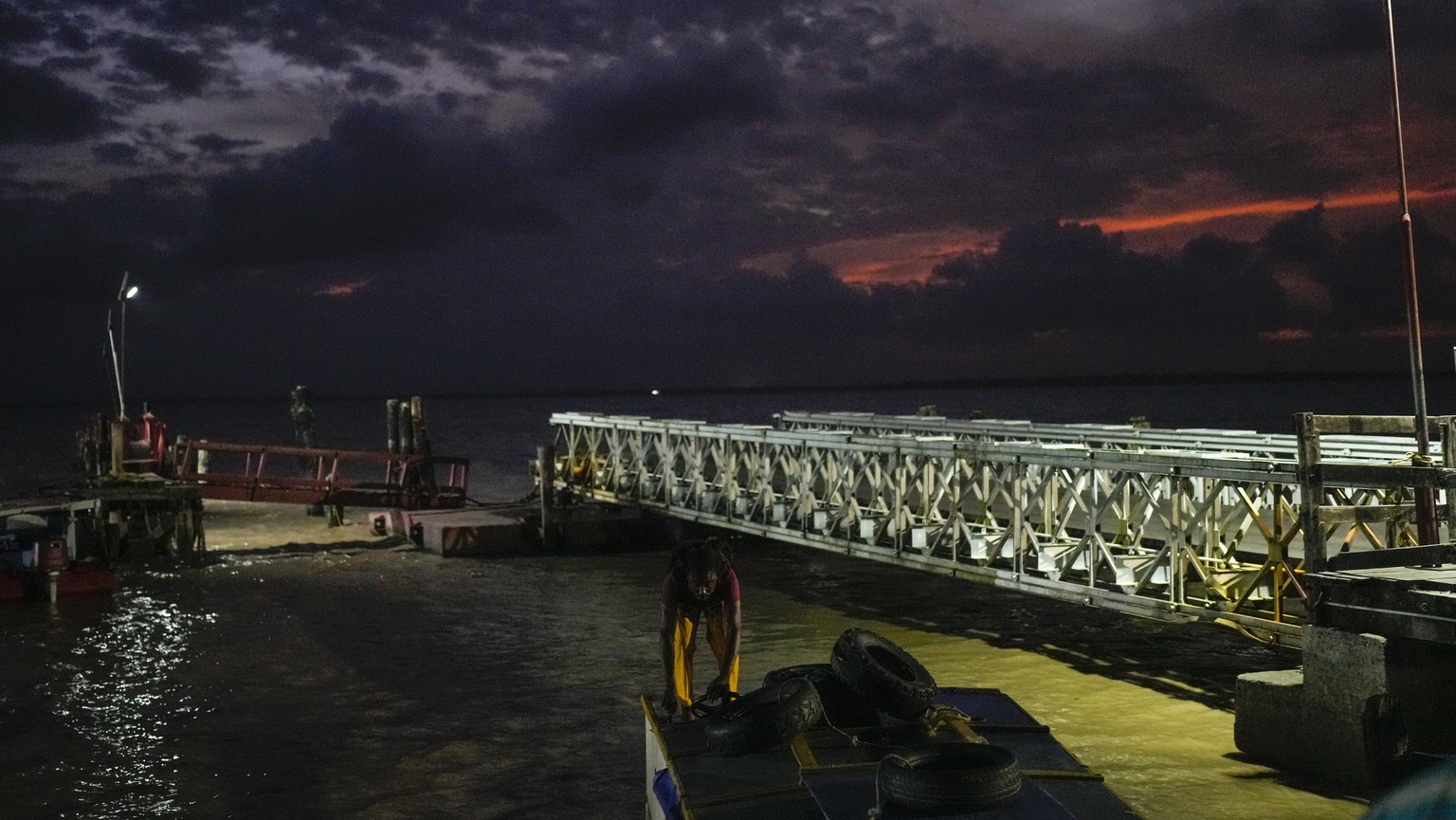 A man docks his boat at the port of Parika, on the mouth of the Essequibo River, Guyana, Monday, April 18, 2023. (AP Photo/Matias Delacroix)