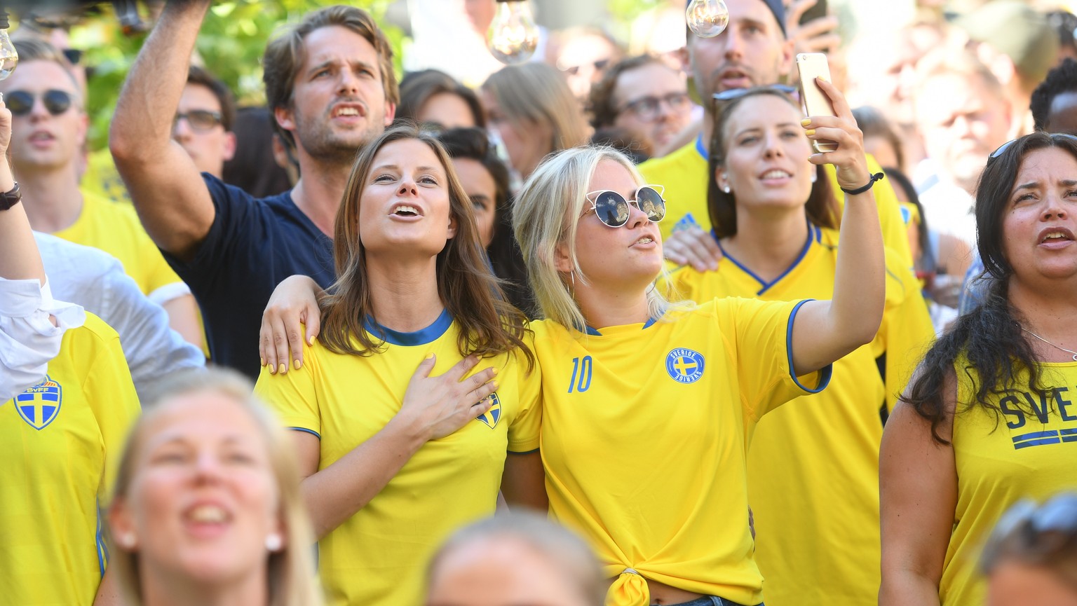 epa06844676 Swedish soccer fans take a selfie as they watch Sweden play against Mexico during the Russia 2018 World Cup Group F soccer match on a big screen outdoors at Norra Bantorget in central Stoc ...