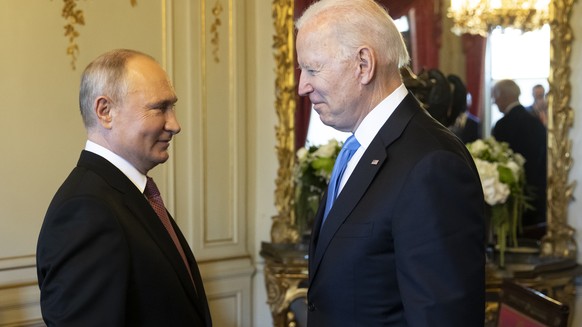 Russian president Vladimir Putin, left, talks to US president Joe Biden after their arrival at the villa La Grange, during the US - Russia summit in Geneva, Switzerland, Wednesday, June 16, 2021. (Swi ...