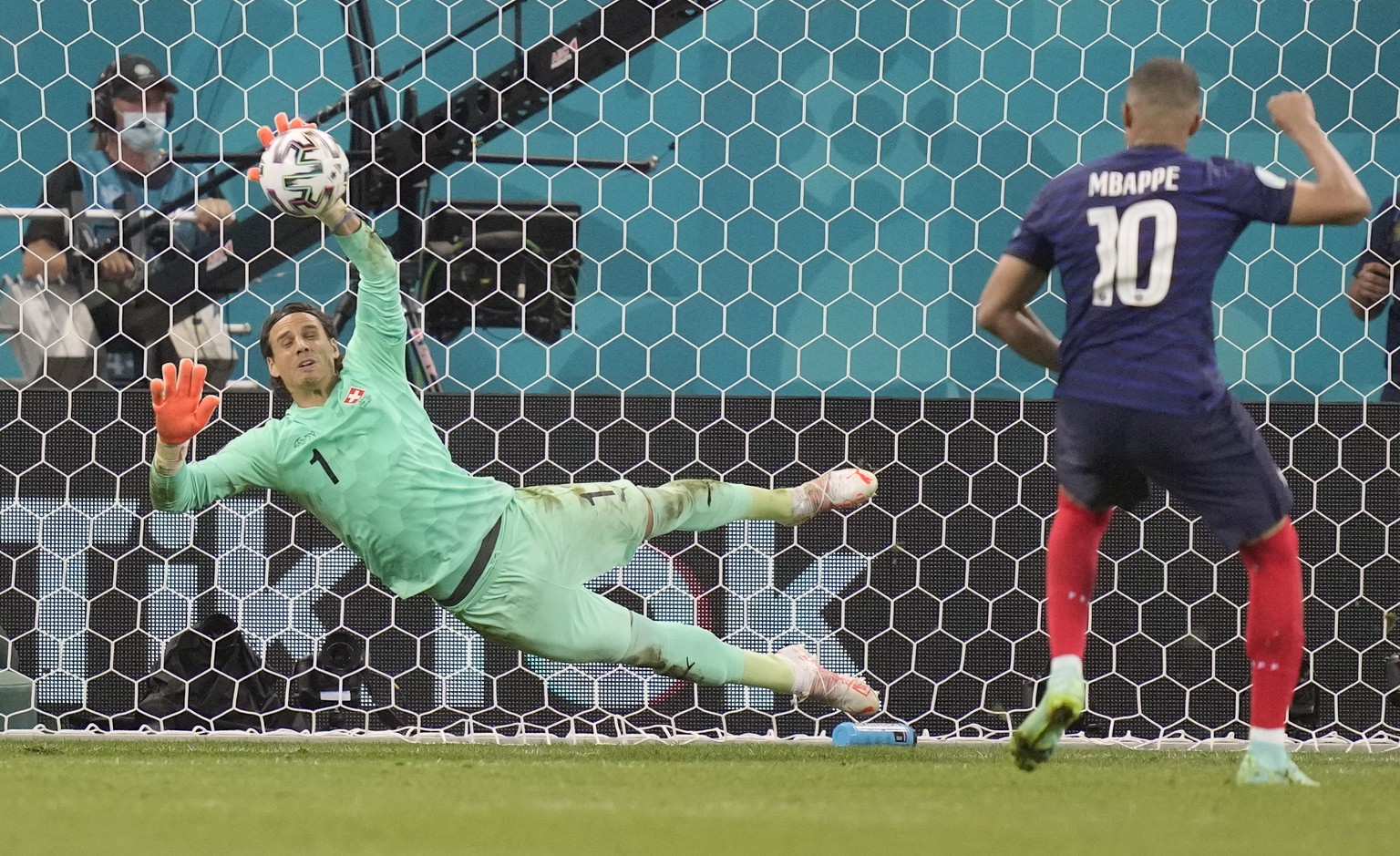 epa09309699 Goalkeeper Yann Sommer of Switzerland saves the kick from Kylian Mbappe of France during penalty shoot-out in the UEFA EURO 2020 round of 16 soccer match between France and Switzerland in  ...