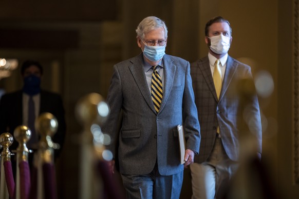 epa08911854 Senate Majority Leader Mitch McConnell walks to the Senate Floor from his office to deliver remarks in the US Capitol in Washington, DC, USA, 30 December 2020. Leader McConnell introduced  ...