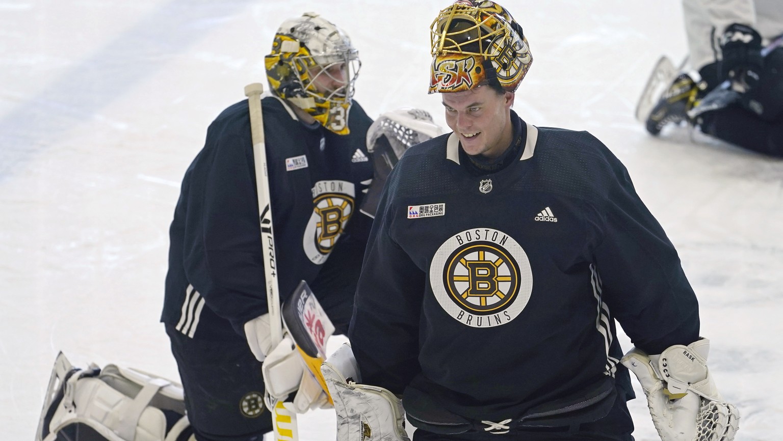 Boston Bruins goaltender Tuukka Rask, right, skates past goaltender Callum Booth at NHL hockey training camp, Monday, Jan. 4, 2021, in Boston. (AP Photo/Elise Amendola)
Tuukka Rask,Callum Booth