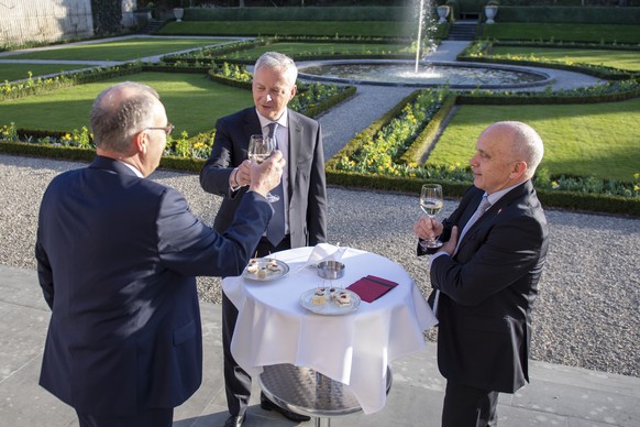 Swiss president Guy Parmelin, left, and federal councillor Ueli Maurer, right, welcome French economy and finance Minister Bruno Le Maire, center, for a bilateral meeting in Bern, Switzerland, Wednesd ...