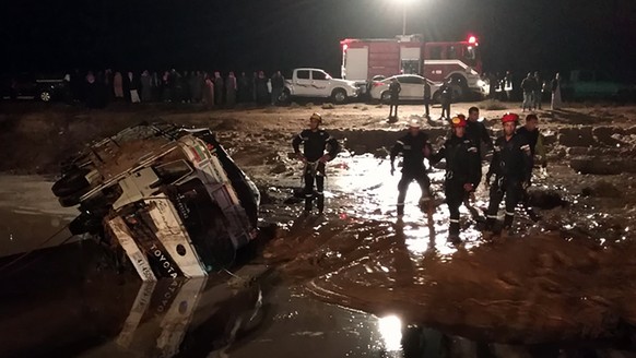 epa07154219 A handout photo made available by the Jordanian News Agency Petra shows members of the Jordanian civil protection services working on a road that was damaged by flash floods, near Madaba,  ...