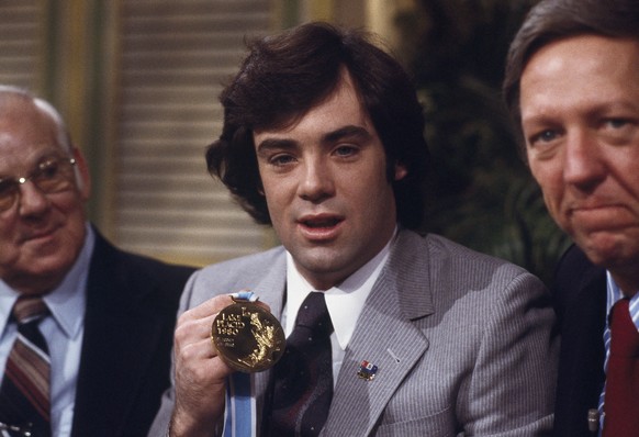 U.S. Olympic hockey team goalie, Jim Craig is flanked by his father, Don, left, and ABC&#039;s Good Morning, America, host David Hartman admiring Gold Medal in Lake Placid, New York, Feb. 26, 1980. (A ...