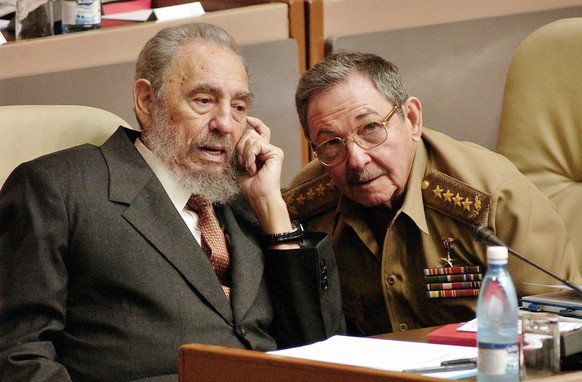 epa05647858 (FILE) A file picture dated 01 July 2004 of Cuban President Fidel Castro (L) talking with his brother and Army Minister Raul (R) during an ordinary session of the National Assembly of the ...