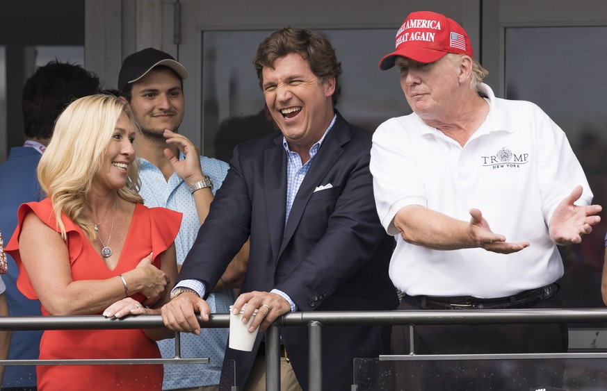 epaselect epa10100951 (L-R) Republican Congresswoman Majorie Taylor Greene of Georgia, Fox News television personality Tucker Carlson, and former US President Donald J. Trump watch the third round of  ...