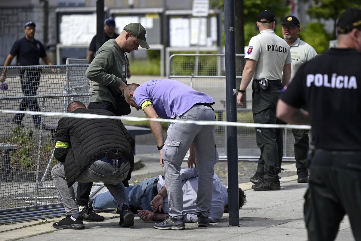 Police arrest a man after Slovak Prime Minister Robert Fico was shot and injured following the cabinet's away-from-home session in the town of Handlova, Slovakia, Wednesday, May 15, 2024. Fico is ...