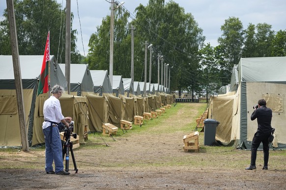 Journalists work at the Belarusian army camp near Tsel village, about 90 kilometers (about 55 miles) southeast of Minsk, Belarus, Friday, July 7, 2023. Maj. Gen. Leonid Kosinsky, an assistant to Belar ...