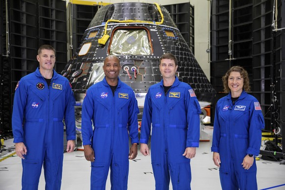 FILE - Artemis II crew members, from left to right, Jeremy Hansen, Victor Glover, Reid Wiseman and Christina Koch, stand together at NASA's Kennedy Space Center in Florida, in front of an Orion crew module...