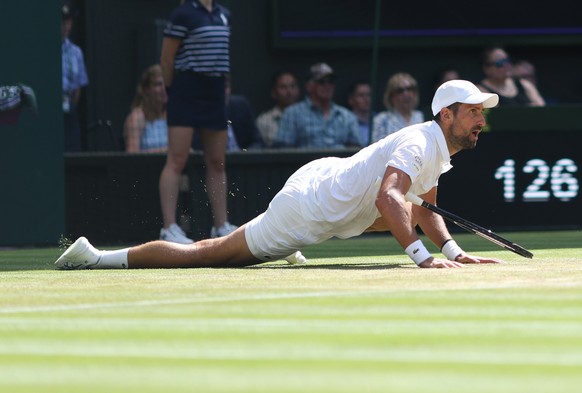 epa13089101 Novak Djokovic of Serbia falls during his Mens Singles fourth round match against Roman Safiullin of Russia at the Wimbledon Championships in London, Britain, 05 July 2026. EPA/ADAM VAUGHA ...