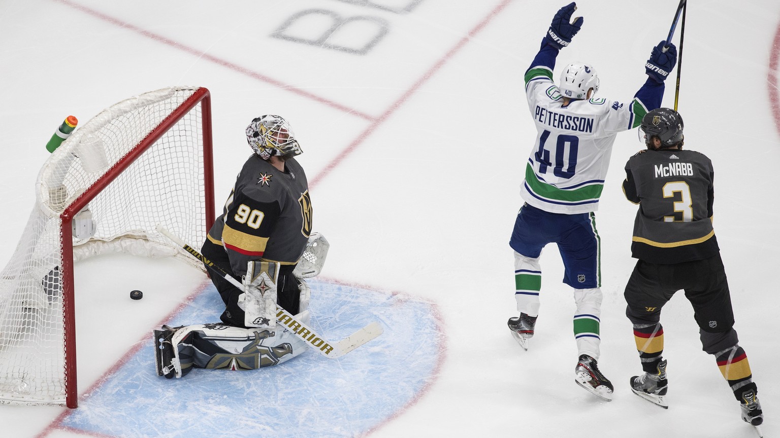 Vancouver Canucks&#039; Elias Pettersson (40) celebrates a goal on Vegas Golden Knights goalie Robin Lehner (90), next to Brayden McNabb (3) during the third period of Game 5 of an NHL hockey second-r ...