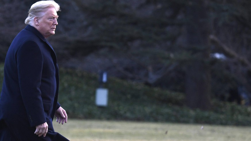 President Donald Trump walks on the South Lawn in a strong brezze, returning to the White House after a day trip to the North Carolina Opportunity Now Summit, Friday, February 7, 2020, in Washington, ...