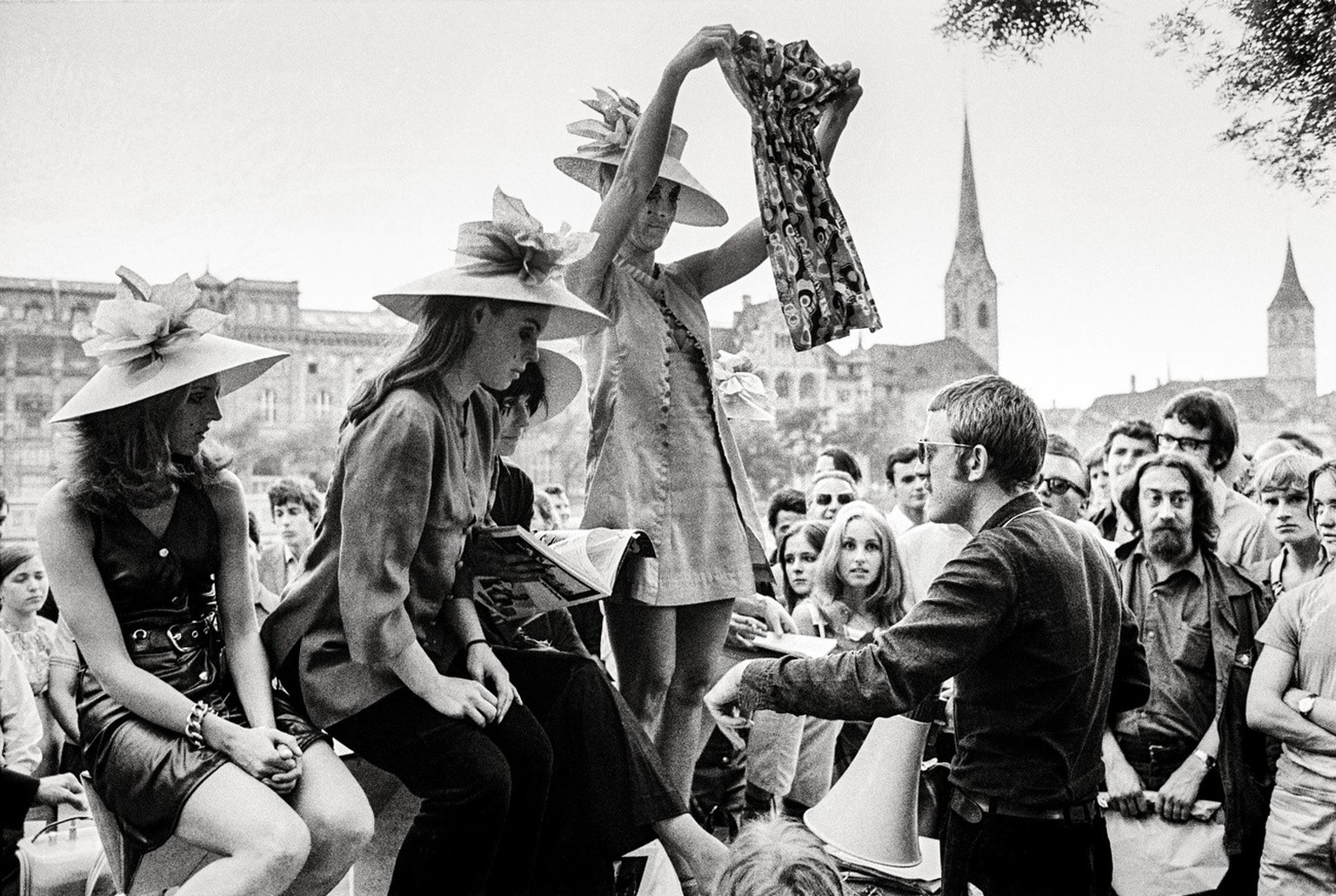 Swiss artists Verena Voiret, center left, standing, and Dieter Meier, center right, standing, and members of the women&#039;s emancipation movement FBB auction off three women&#039;s dresses including ...