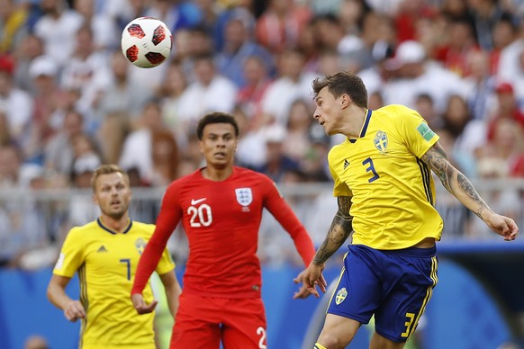 England&#039;s Dele Alli looks at Sweden&#039;s Victor Lindelof, front, head the ball during the quarterfinal match between Sweden and England at the 2018 soccer World Cup in the Samara Arena, in Sama ...