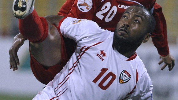 United Arab Emirates&#039;s player Ismaeil Matar, foreground, fights for ball against Iran&#039;s player Mohammad Nosrati during their AFC Asian Cup group D soccer match at Qatar Sports Stadium, in Do ...