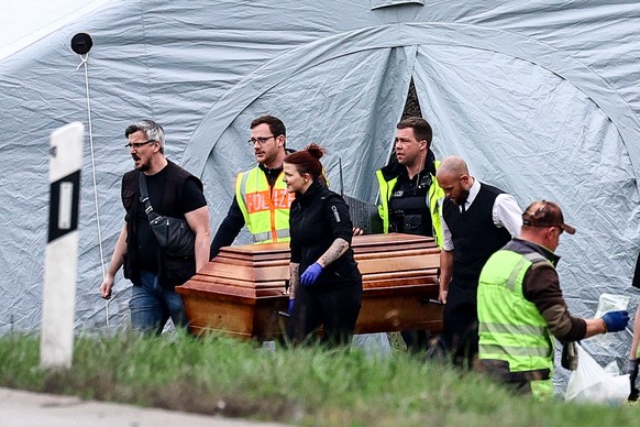 epa11247023 The body of a victim is removed from the scene of a bus accident on the A9 highway in Schkeuditz, near Leipzig, Germany, 27 March 2024. At least five people died and several others were in ...