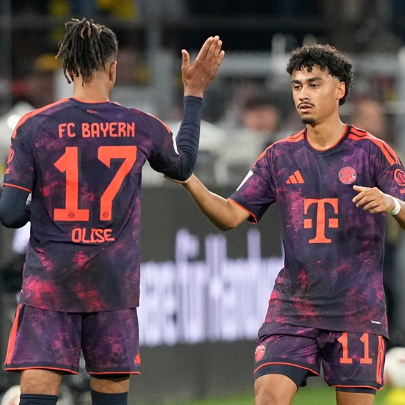 Bayern's Nathaniel Brown, right, is congratulated by Michael Olise after scoring his side's opening goal during the Franz Beckenbauer German Supercup soccer match between Borussia Dortmund a ...