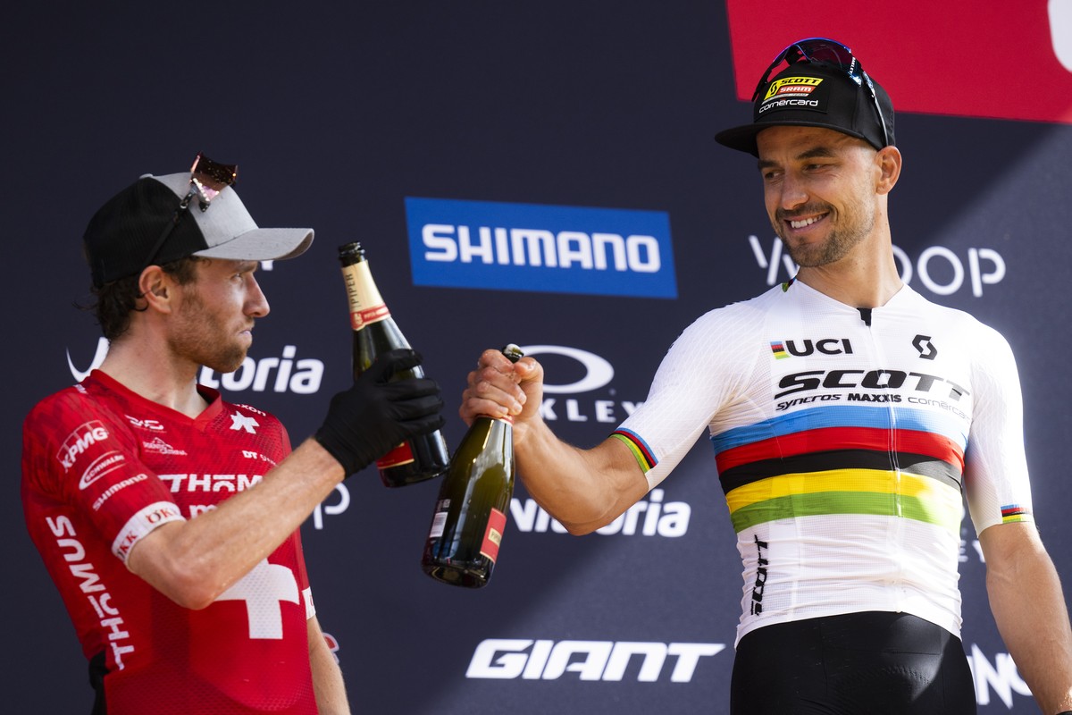 Second placed Mathias Flueckiger of Switzerland, left, and winner Nino Schurter of Switzerland, after the UCI Cross Country Mountain Bike World Cup, on Sunday, July 2, 2023, in Val di Sole, Italy. (KE ...