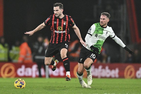 epa11094886 Lewis Cook of Bournemouth (L) battles with Alexis Mac Allister of Liverpool (R) during the English Premier League soccer match between AFC Bournemouth and Liverpool FC, in Bournemouth, Bri ...