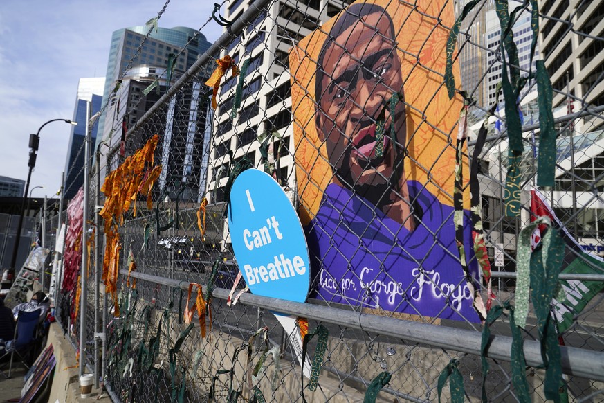 A picture of George Floyd hangs on a fence outside the Hennepin County Government Center, Tuesday, March 30, 2021, in Minneapolis where the trial for former Minneapolis police officer Derek Chauvin co ...