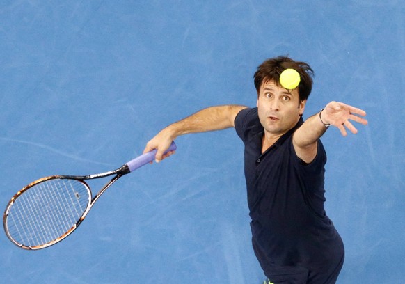 Micromax Indian Aces&#039; Fabrice Santoro of France serves to Manila Mavericks&#039; Mark Philippoussis of Australia during their match at the International Premier Tennis League (IPTL) in Dubai Dece ...