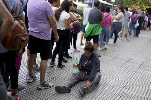 People line up outside the office of Minister of Human Capital Sandra Pettovello, in response to the minister stating that she will personally help the hungry, in Buenos Aires, Argentina, Monday, February 5, 20…
