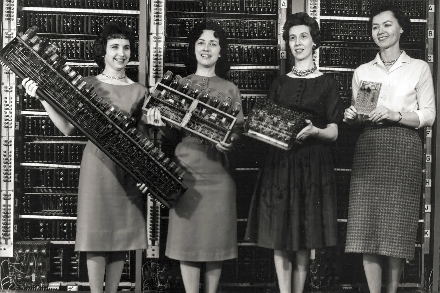 Patsy Simmers, holding ENIAC board; Gail Taylor, holding EDVAC board; Milly Beck, holding ORDVAC board; and Norma Stec, holding BRLESC-I board.