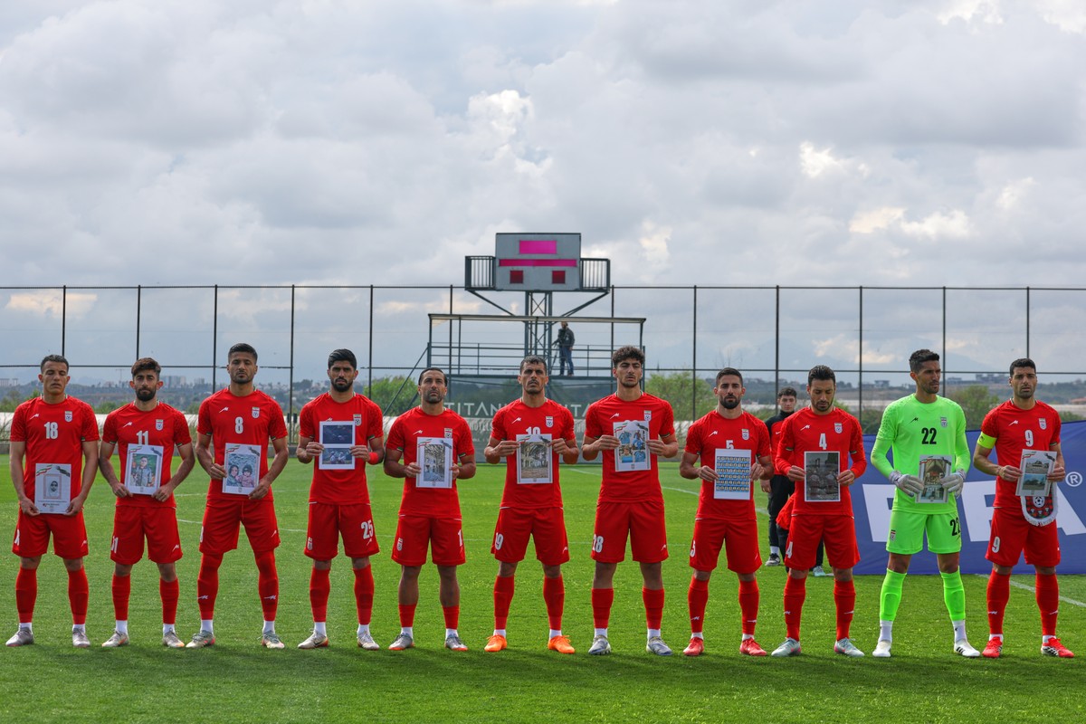 KEYPIX - Iran's players sing national anthem holding pictures of children allegedly killed in a U.S. and Israel strikes in Iran, before a friendly soccer match between Iran and Costa Rica, in Ant ...