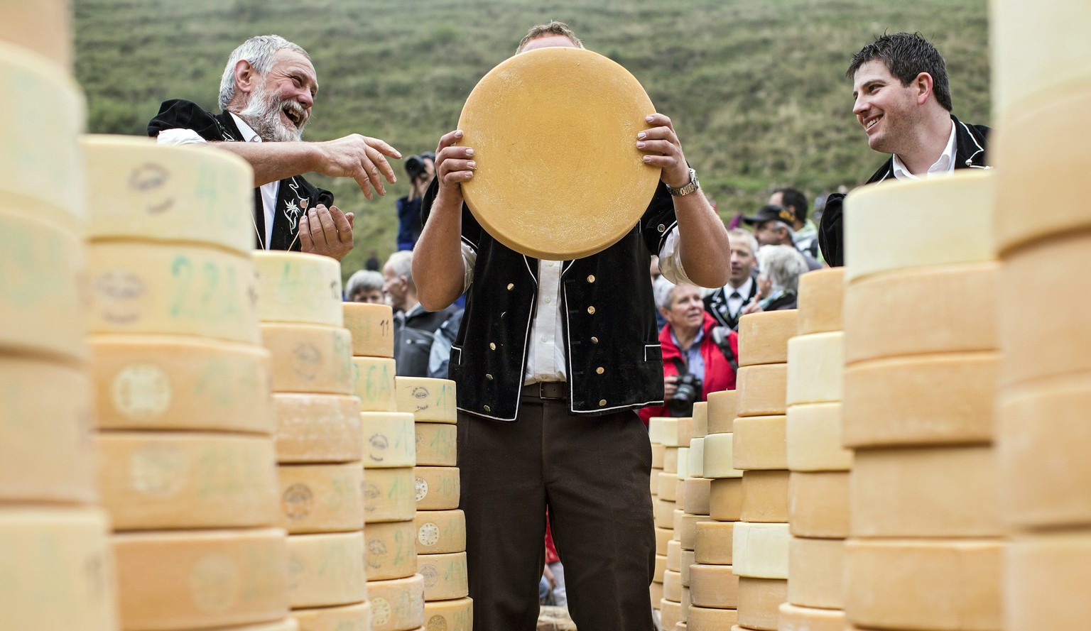epa04936862 epa04936860 Dairy farmers attend traditional Chaesteilet (lit.: sharing the cheese) in Justistal, Switzerland, 18 September 2015. The local farmers whose cows have spend the summer on the  ...