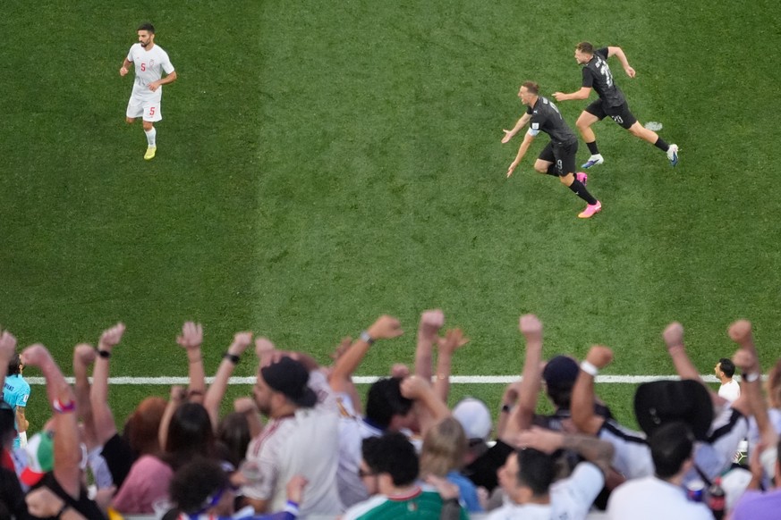 New Zealand's Chris Wood (9) and Callum McCowatt (20) celebrate after teammate Elijah Just scored their second goal during the World Cup Group G soccer match between Iran and New Zealand in Ingle ...