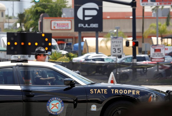 A Florida State Trooper blocks the road leading to the site of the shooting at the Pulse gay night club in Orlando, Florida, June 13, 2016. REUTERS/Jim Young