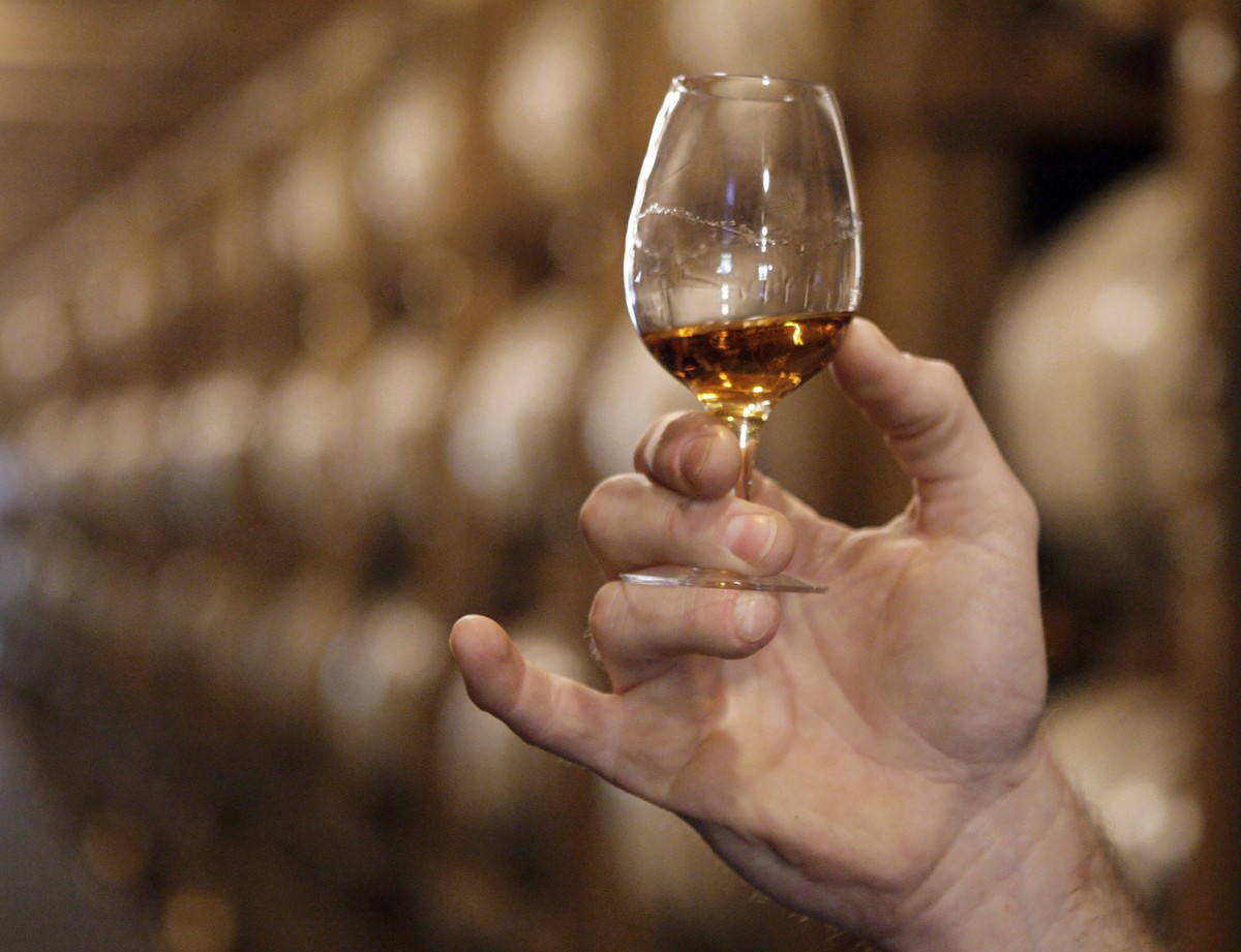 FILE - In this May 20, 2009 file photo, a glass of Jack Daniel's whiskey is examined after being taken from an aging barrel in one of the barrel houses at the distillery in Lynchburg, Tenn. Ameri ...