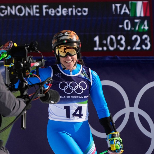 Italy's Federica Brignone at the finish area of an alpine ski, women's giant slalom race, at the 2026 Winter Olympics, in Cortina d'Ampezzo, Italy, Sunday, Feb. 15, 2026. (AP Photo/Andy ...